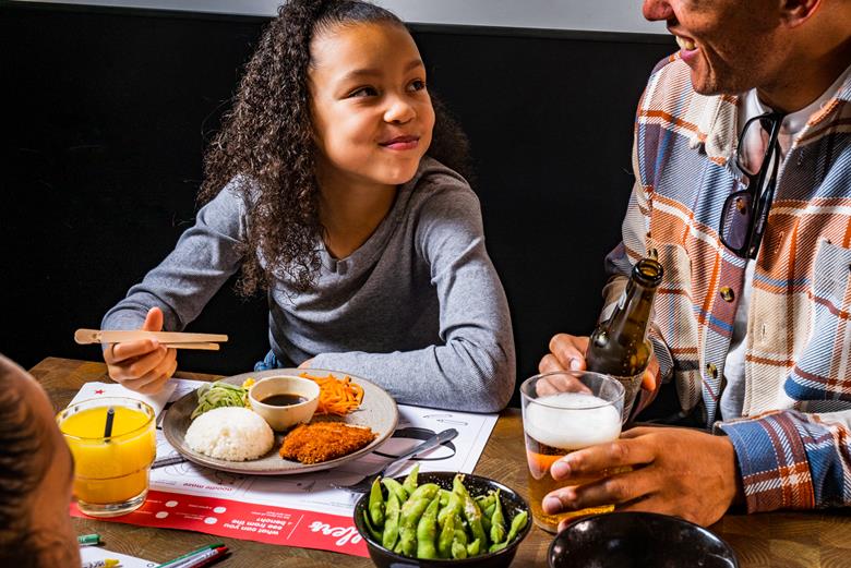 A man and girl eating in Wagamama