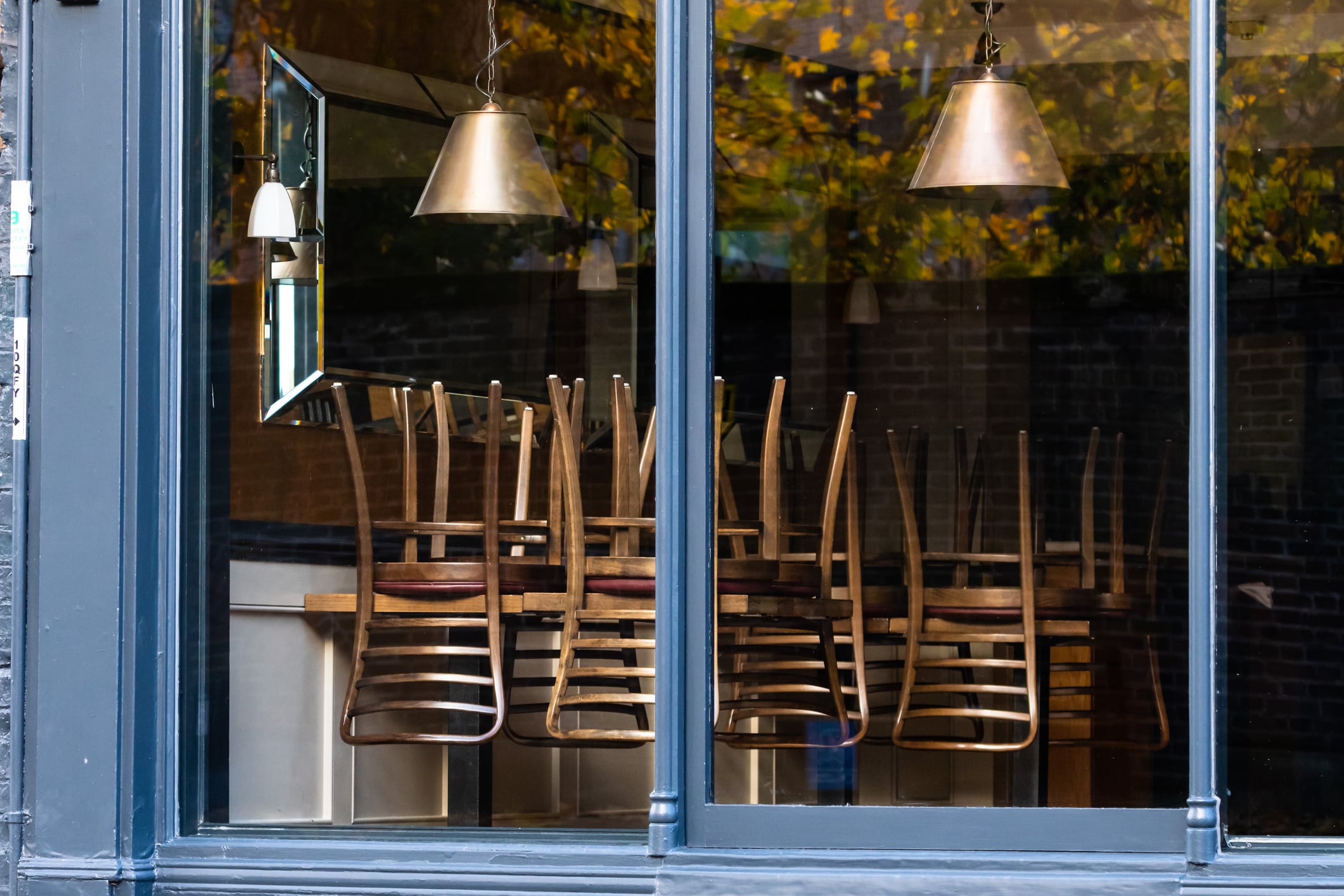 Chairs on the tables of a restaurant forced to close during lockdown to control COVID-19 pandemic, Cambridge, UK
