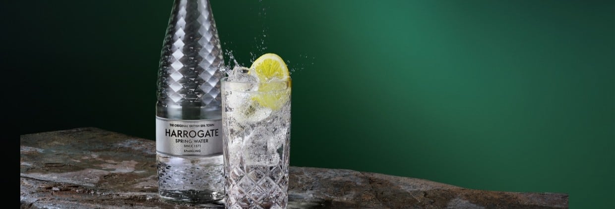 Bottle of sparkling water with glass