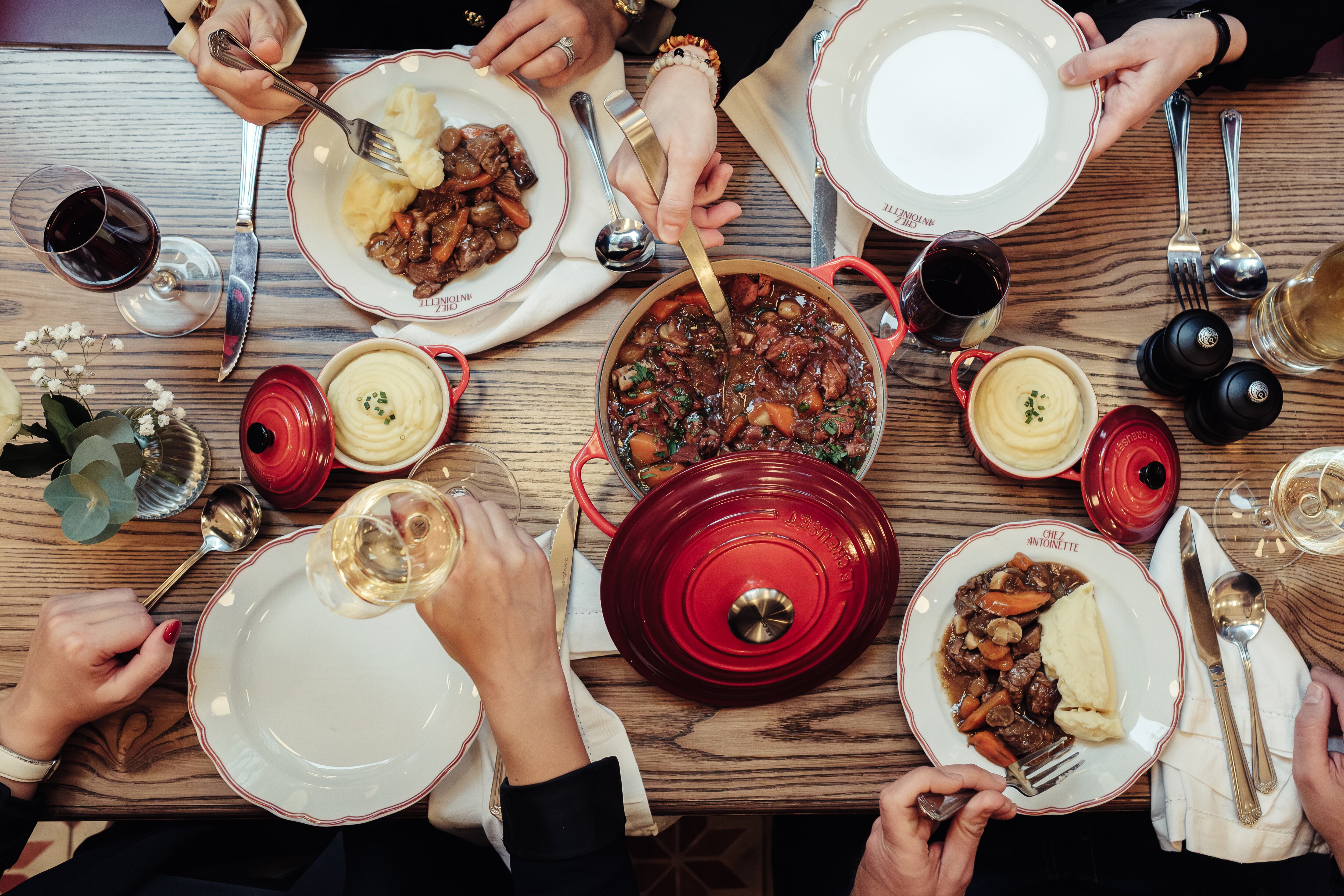 People serving themselves French food at Chez Antoinette
