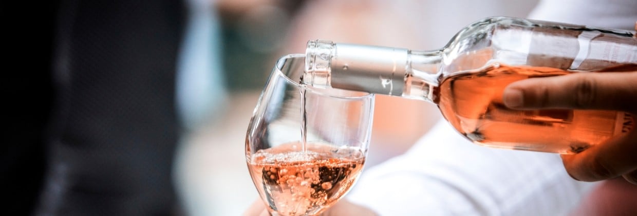 Pouring rose wine into a glass