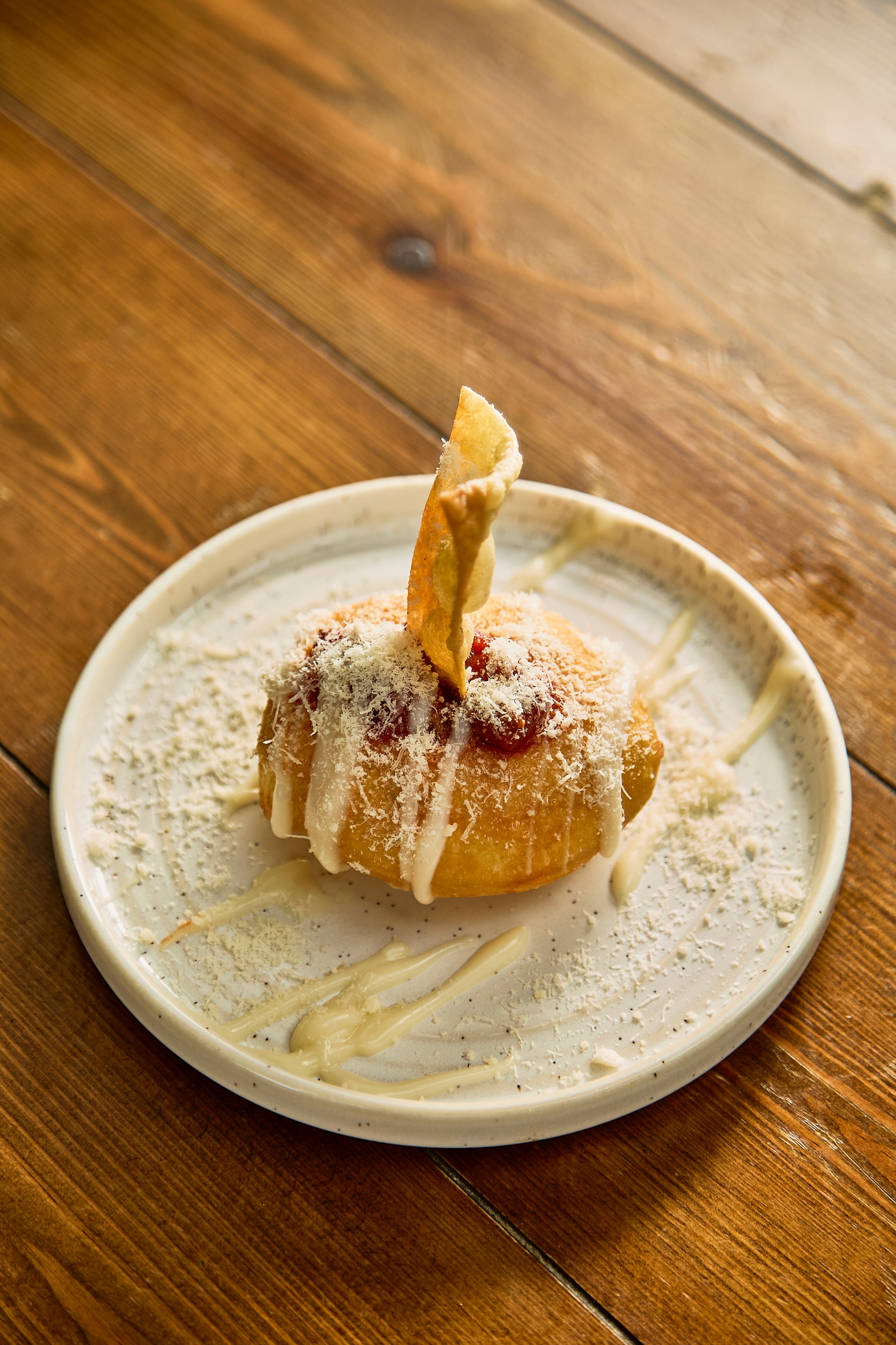 Crust Bros' Lasagna Bomba made with six-hour ragu, parmesan, bechamel, and a deep fried lasagna sheet