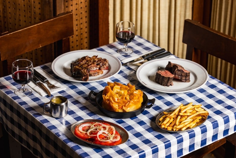 Steak and chicken on a table at Solis