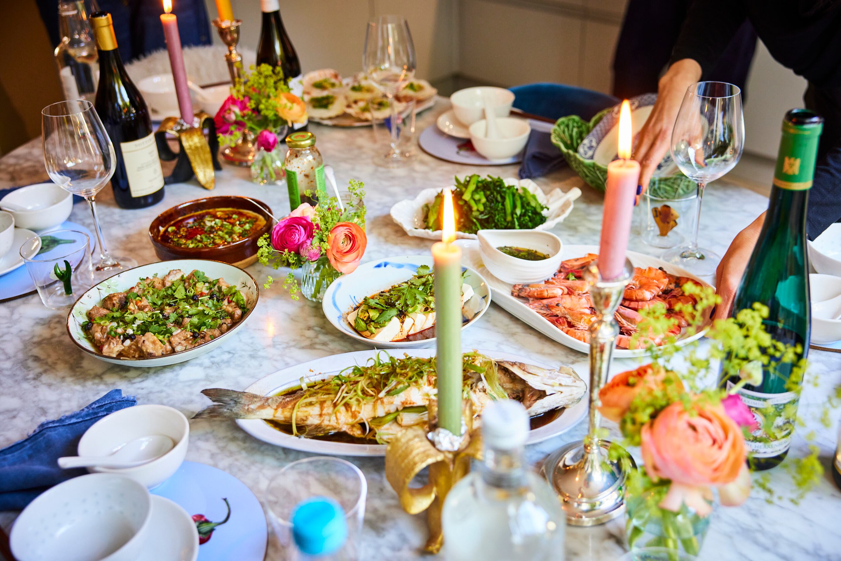 A table of Chinese food with candles