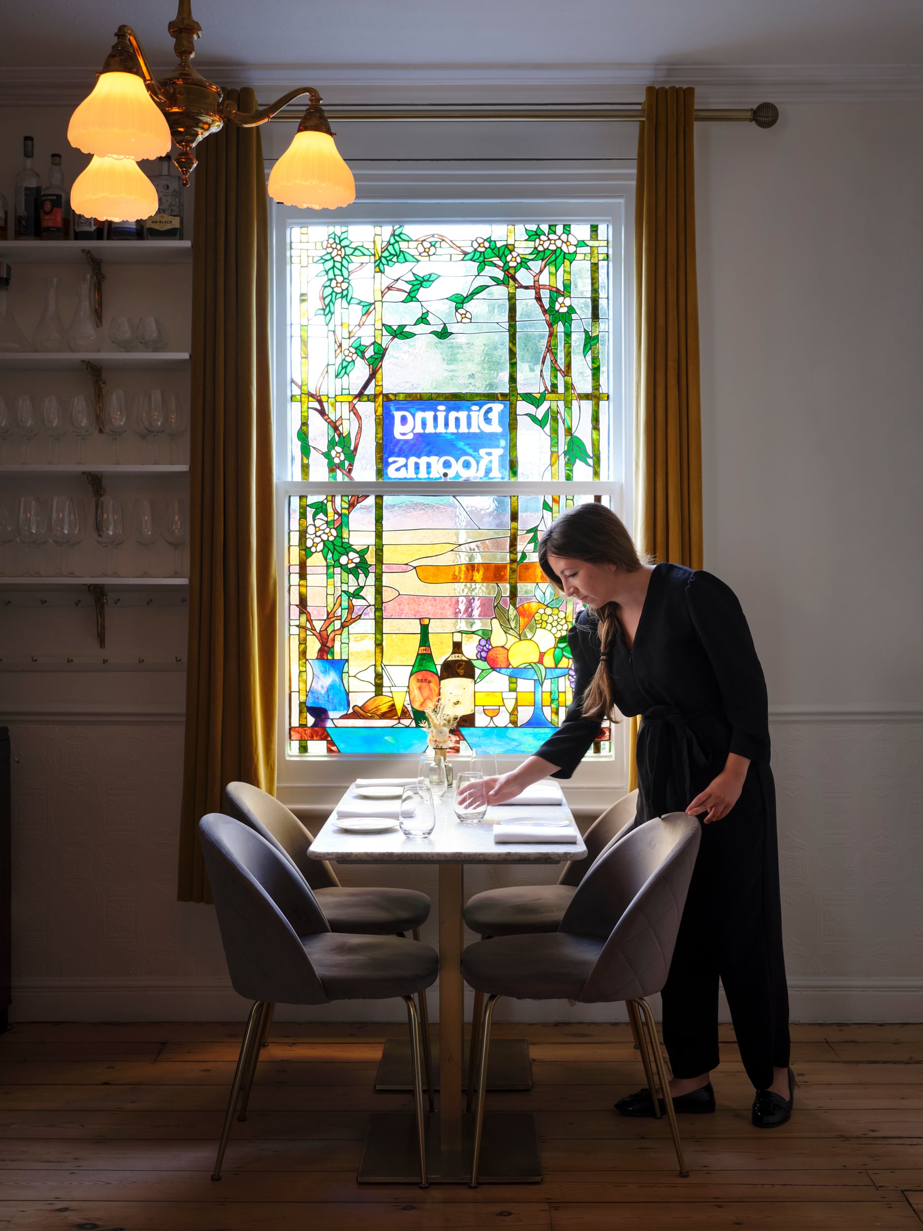 A waiter laying a table at Restaurant 22 in Cambridge