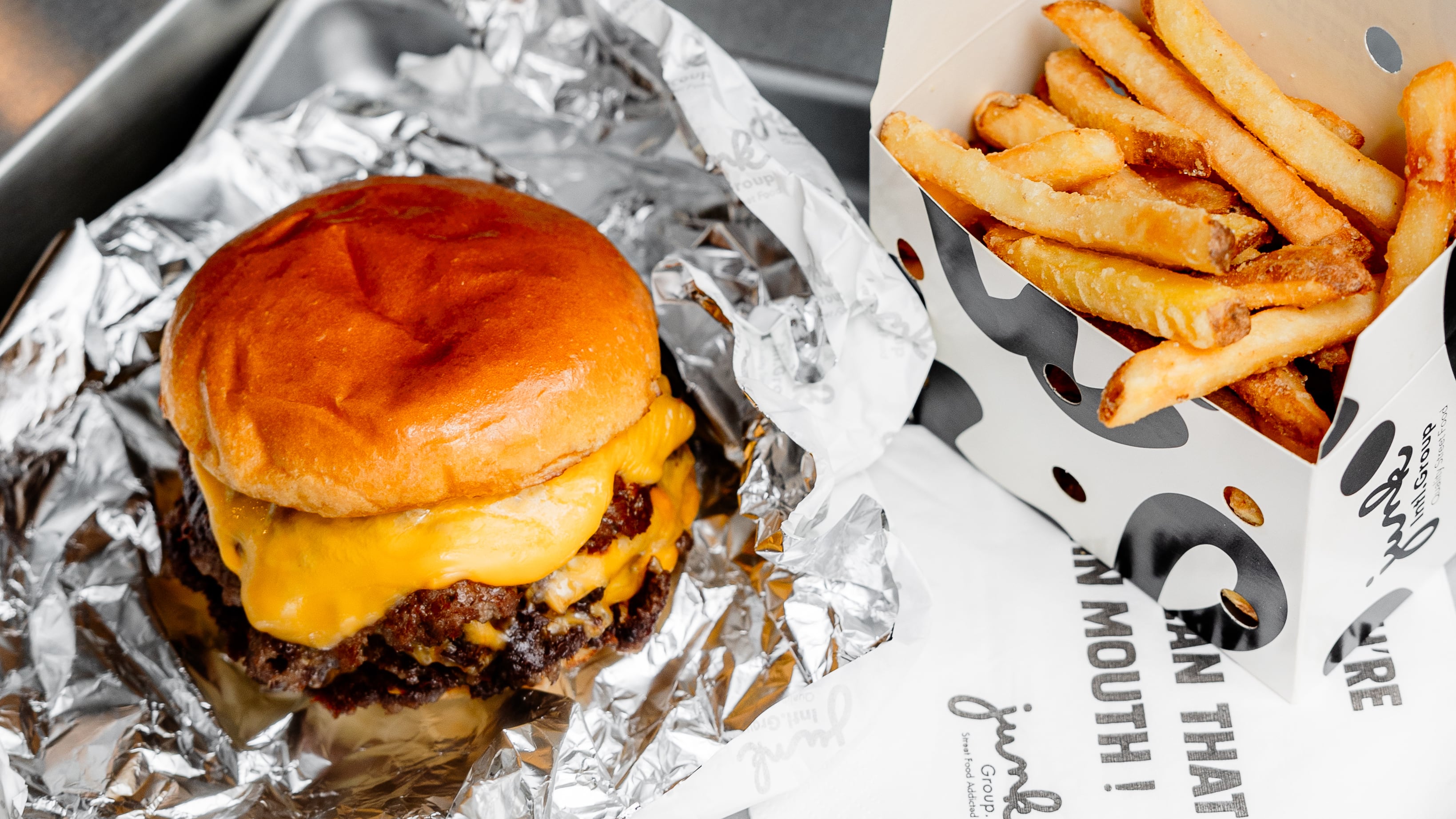 Smash burger and chips on a tray from Junk Burger