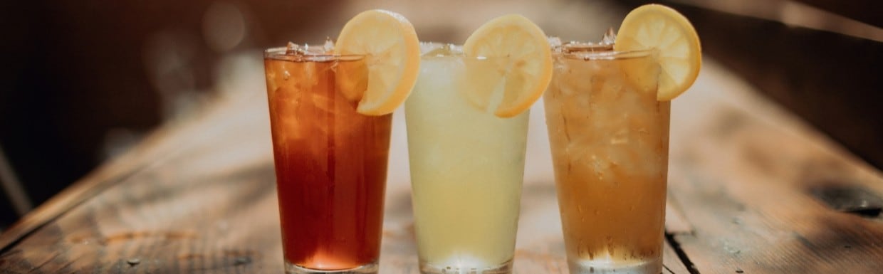 3 colourful summer drinks on restaurant table