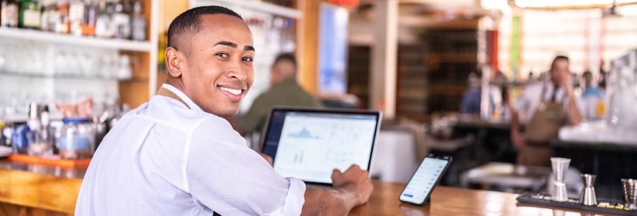 Restaurant worker using tech to review business performance