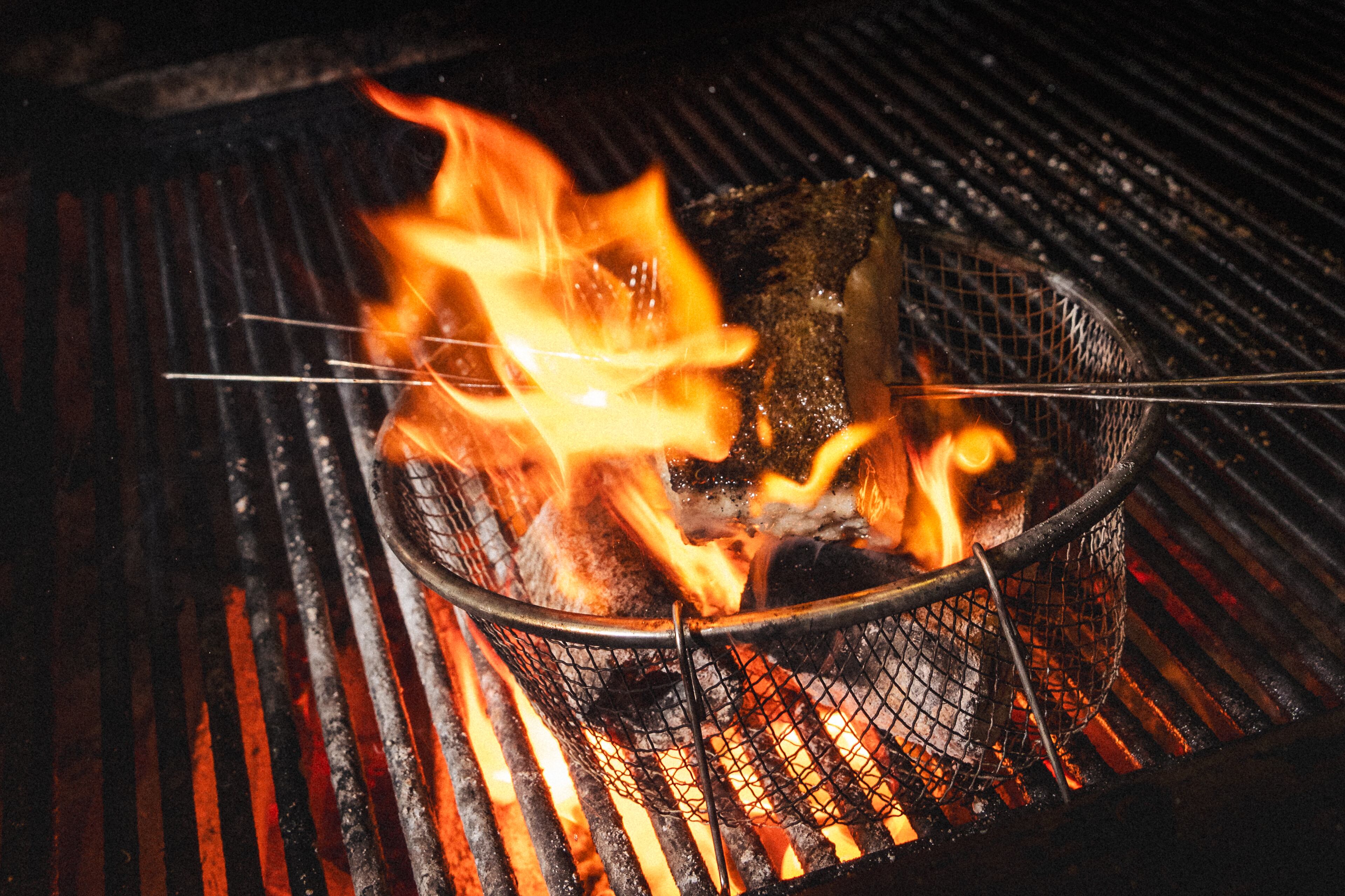 A basket of flames on a grill
