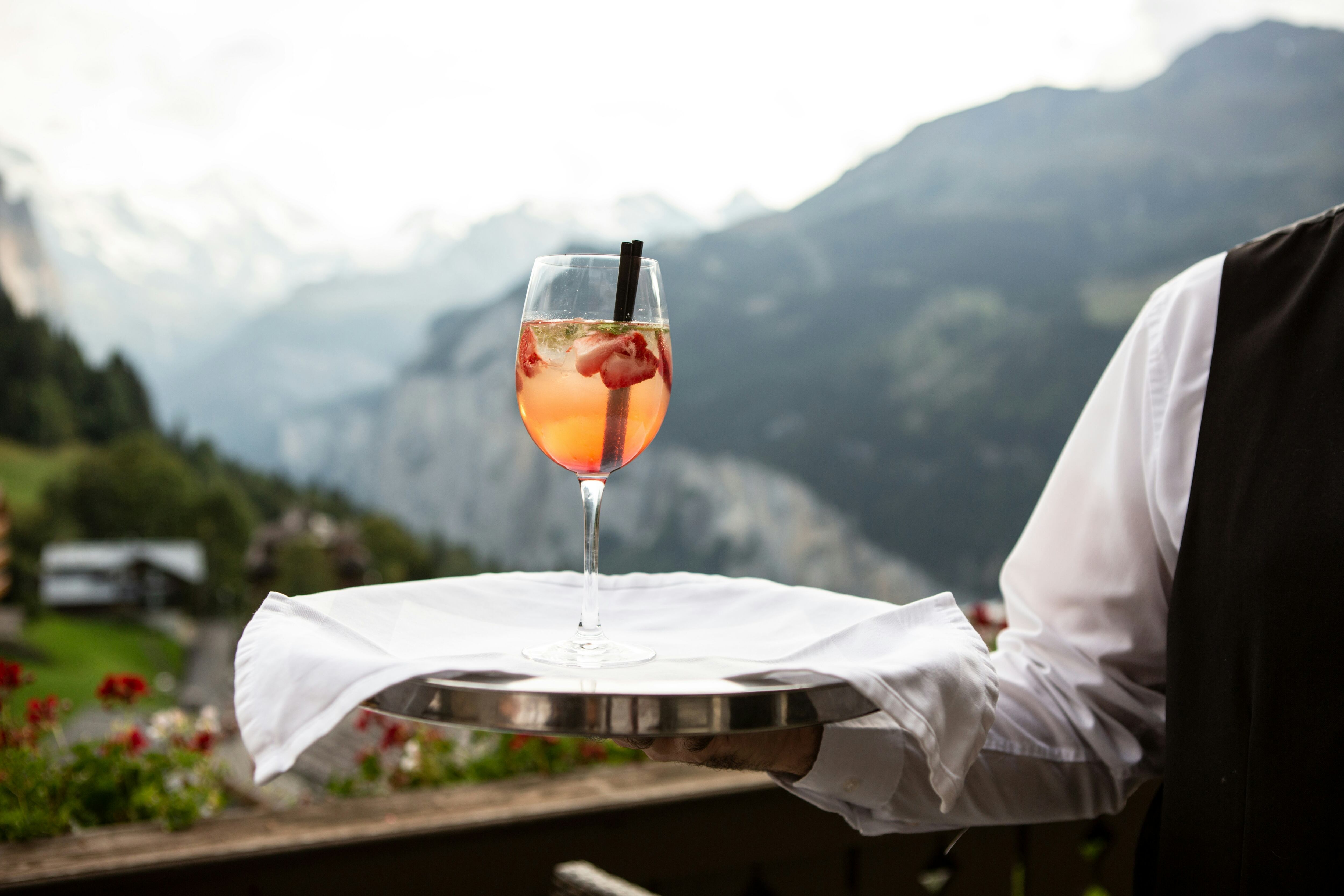 Aperol spritz served in a glass overlooking the mountains