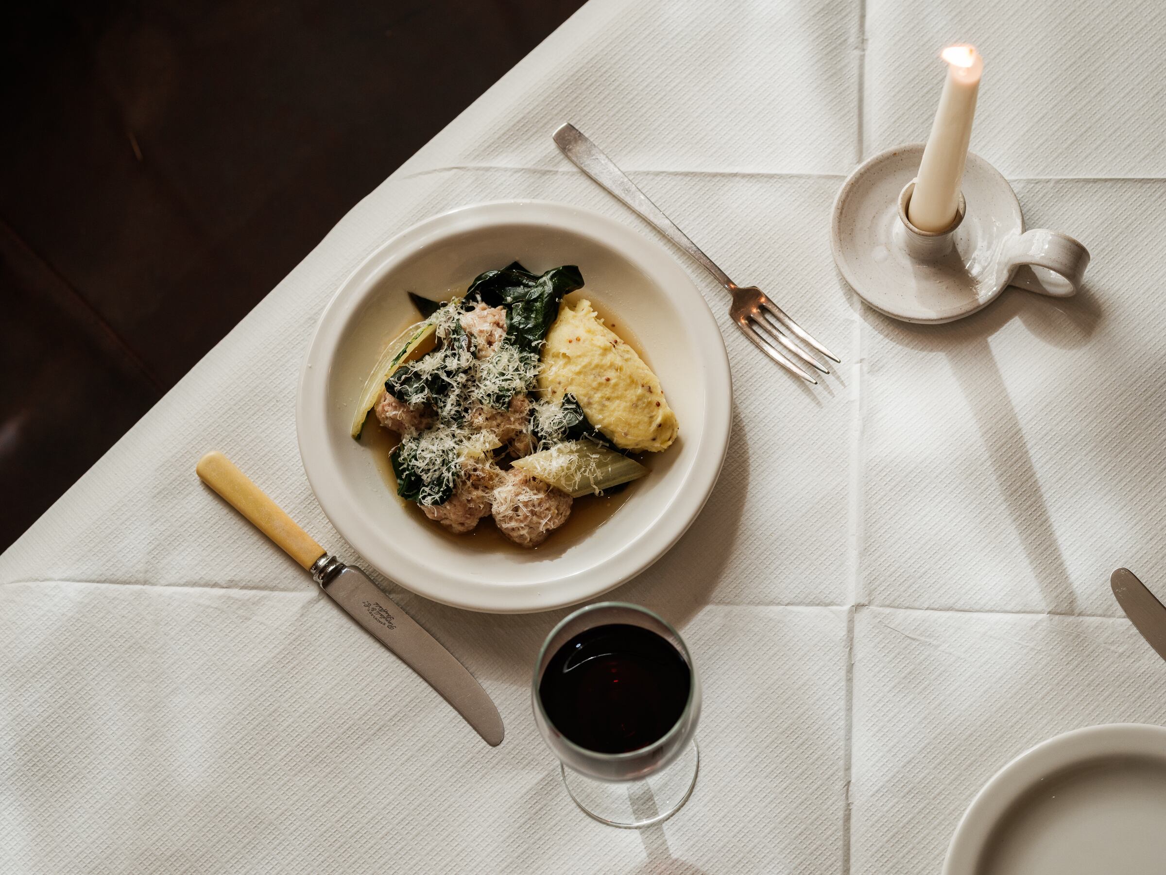 Meatballs and chard and glass of red wine