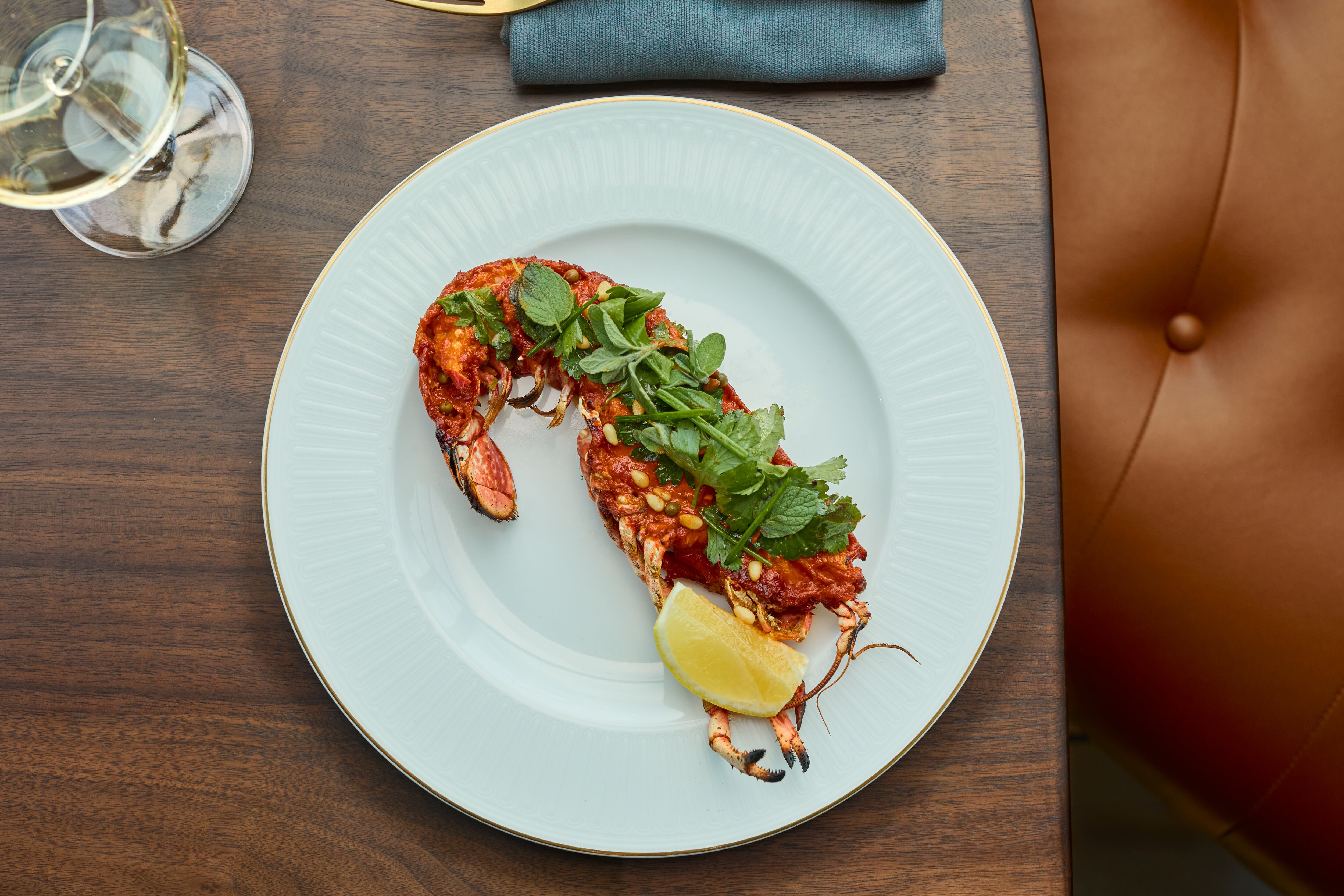 Grilled half native lobster, served with tomato and pine nut brown butter, green peppercorn, and herb salad at Gilroy's Loft