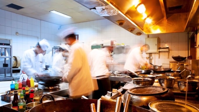 Chefs at work in restaurant kitchen