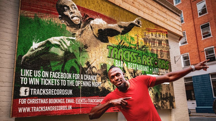 Usain-in-front-of-hoarding.png