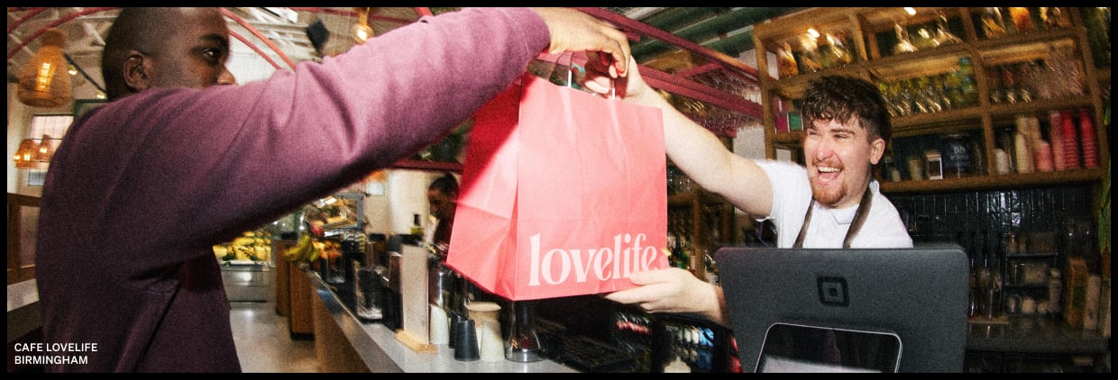 Handing a bag over the counter in a restaurant