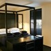 La Suite West features individually crafted four-poster beds set against whitewashed rooms with black wooden shutters